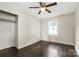 Simple bedroom with dark wood floors, ceiling fan, and closet at 323 20Th St, Kannapolis, NC 28083