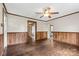 Living room with wood floors, ceiling fan, and wood paneling at 323 20Th St, Kannapolis, NC 28083