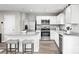 Modern kitchen with white cabinets, granite countertops, and stainless steel appliances at 2553 Bruner Ct, China Grove, NC 28023