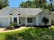 Charming one-story home with gray siding, landscaping, and a two-car garage at 258 Indian Paint Brush Dr, Mooresville, NC 28115