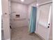 Large accessible shower with grab bars and tiled walls at 416 Witten Ln, Gastonia, NC 28052