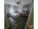 Cozy bedroom with hardwood floors, ceiling fan, and window coverings at 416 Witten Ln, Gastonia, NC 28052
