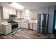 Updated kitchen with stainless steel appliances and light gray cabinets at 416 Witten Ln, Gastonia, NC 28052