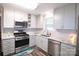 Updated kitchen with stainless steel appliances and light gray cabinets at 416 Witten Ln, Gastonia, NC 28052