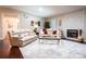 Relaxing living room with leather sofas, a fireplace, and hardwood floors at 3711 Davis Dr, Charlotte, NC 28270