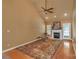 Living room with hardwood floors, fireplace, and ceiling fan at 7300 Wahoo Ct, Gastonia, NC 28056