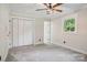 Bedroom with white closet doors and ceiling fan at 4165 Laurelwood Ct, Concord, NC 28025