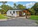 Modern farmhouse exterior with covered porch and gravel driveway at 4165 Laurelwood Ct, Concord, NC 28025