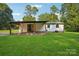 Rear view of house, showcasing the covered porch and landscaping at 4165 Laurelwood Ct, Concord, NC 28025