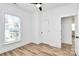 Bright bedroom with wood-look floors, ceiling fan, and ample closet space at 3230 Rogers St, Charlotte, NC 28208