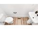 Modern powder room with pedestal sink and light wood floor at 3230 Rogers St, Charlotte, NC 28208