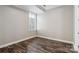 Spacious bedroom with hardwood floors and neutral walls at 230 S Tryon St # 704, Charlotte, NC 28202