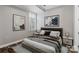 Spacious bedroom with large bed and plenty of natural light at 230 S Tryon St # 704, Charlotte, NC 28202