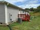 Gray mobile home with red deck, AC unit, and small yard at 280 Deerfield Estates Ln, Stony Point, NC 28678