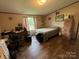 Well-lit bedroom featuring a desk and large window at 280 Deerfield Estates Ln, Stony Point, NC 28678