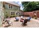 Relaxing patio with fire pit, surrounded by a brick wall and lush greenery at 8244 Dumphries Dr, Huntersville, NC 28078