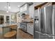 Bright kitchen with stainless steel appliances and an island at 8244 Dumphries Dr, Huntersville, NC 28078