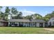 Ranch home with white exterior, gray roof, and a well-manicured lawn at 5220 Seacroft Rd, Charlotte, NC 28210