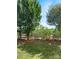 Landscaped backyard with split rail fence and lush green grass at 16841 Greenlawn Hills Ct, Charlotte, NC 28213