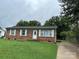 Brick ranch home with a well-maintained lawn and driveway at 2307 Dallas Stanley Hwy, Stanley, NC 28164