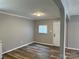 Dining room features gray walls, wood-look floors, and a white door at 2307 Dallas Stanley Hwy, Stanley, NC 28164