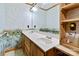Bathroom with double vanity, wood cabinets, and nature-themed wallpaper at 902 Coldwater Ct, Concord, NC 28025