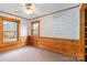 Bedroom with wood-paneled walls and two windows at 902 Coldwater Ct, Concord, NC 28025