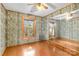 Bedroom with wood walls, large mirror and ceiling fan at 902 Coldwater Ct, Concord, NC 28025