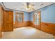 Cozy bedroom with wood paneling, a ceiling fan and window views at 902 Coldwater Ct, Concord, NC 28025