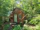 Rustic wood cabin nestled in a lush forest setting at 902 Coldwater Ct, Concord, NC 28025
