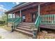 Inviting front porch with wooden railings and rocking chairs, perfect for relaxing at 902 Coldwater Ct, Concord, NC 28025