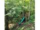 Wooden treehouse with slide and deck in a wooded area at 902 Coldwater Ct, Concord, NC 28025
