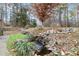 Charming water feature with rocks and lush greenery, adding tranquility to the landscape at 902 Coldwater Ct, Concord, NC 28025