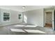 Sunlit bedroom with carpet, neutral walls and a hallway view at 5009 Heathland Dr # 63, Charlotte, NC 28215