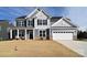 Two-story house with gray siding, white garage door, and landscaping at 112 Wedge View Way, Statesville, NC 28677