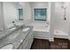 Elegant bathroom with granite countertop, double sinks, and a garden tub at 1319 Baucom Rd, Monroe, NC 28110