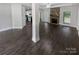 Open living room with hardwood floors and a stone fireplace at 1319 Baucom Rd, Monroe, NC 28110