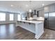 Modern kitchen with gray cabinets, white quartz countertops, and stainless steel appliances at 2642 Roseglen Ln, Indian Land, SC 29707