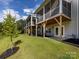 Landscaped backyard with a large screened porch and patio at 2642 Roseglen Ln, Indian Land, SC 29707