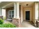 Inviting front porch with stone pillars and a bench at 14613 Glenduff Pl, Charlotte, NC 28278