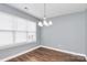 Dining room with hardwood floors and large window with blinds at 10814 Greenhead View Rd, Charlotte, NC 28262