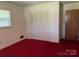 Bedroom with double door closet and red carpet at 1701 W A St, Kannapolis, NC 28081