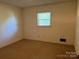 Bright bedroom featuring neutral walls and carpet at 1701 W A St, Kannapolis, NC 28081