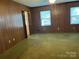 Spacious living room with wood paneled walls and large windows at 1701 W A St, Kannapolis, NC 28081