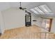 Open living room with hardwood floors, fireplace, and skylights at 1720 12Th Ne St, Hickory, NC 28601