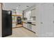 Kitchen with white cabinets, tile backsplash and black appliances at 1720 12Th Ne St, Hickory, NC 28601