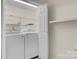 Functional laundry room with washer, dryer, and shelving at 1720 12Th Ne St, Hickory, NC 28601