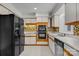 Kitchen with white cabinets, a tile backsplash, and black appliances at 1720 12Th Ne St, Hickory, NC 28601
