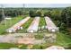 Aerial view of a farm with several long chicken coops and silos at 12136 Renee Ford Rd, Stanfield, NC 28163