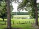 Serene pond view with lush green grass and trees at 12136 Renee Ford Rd, Stanfield, NC 28163
